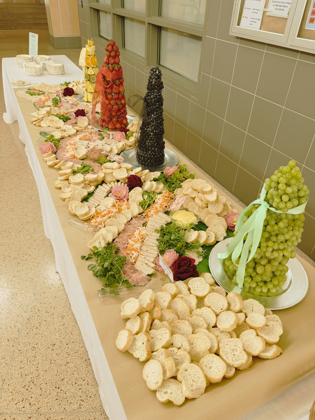 Grand buffet display with breads, fruits, and charcuterie