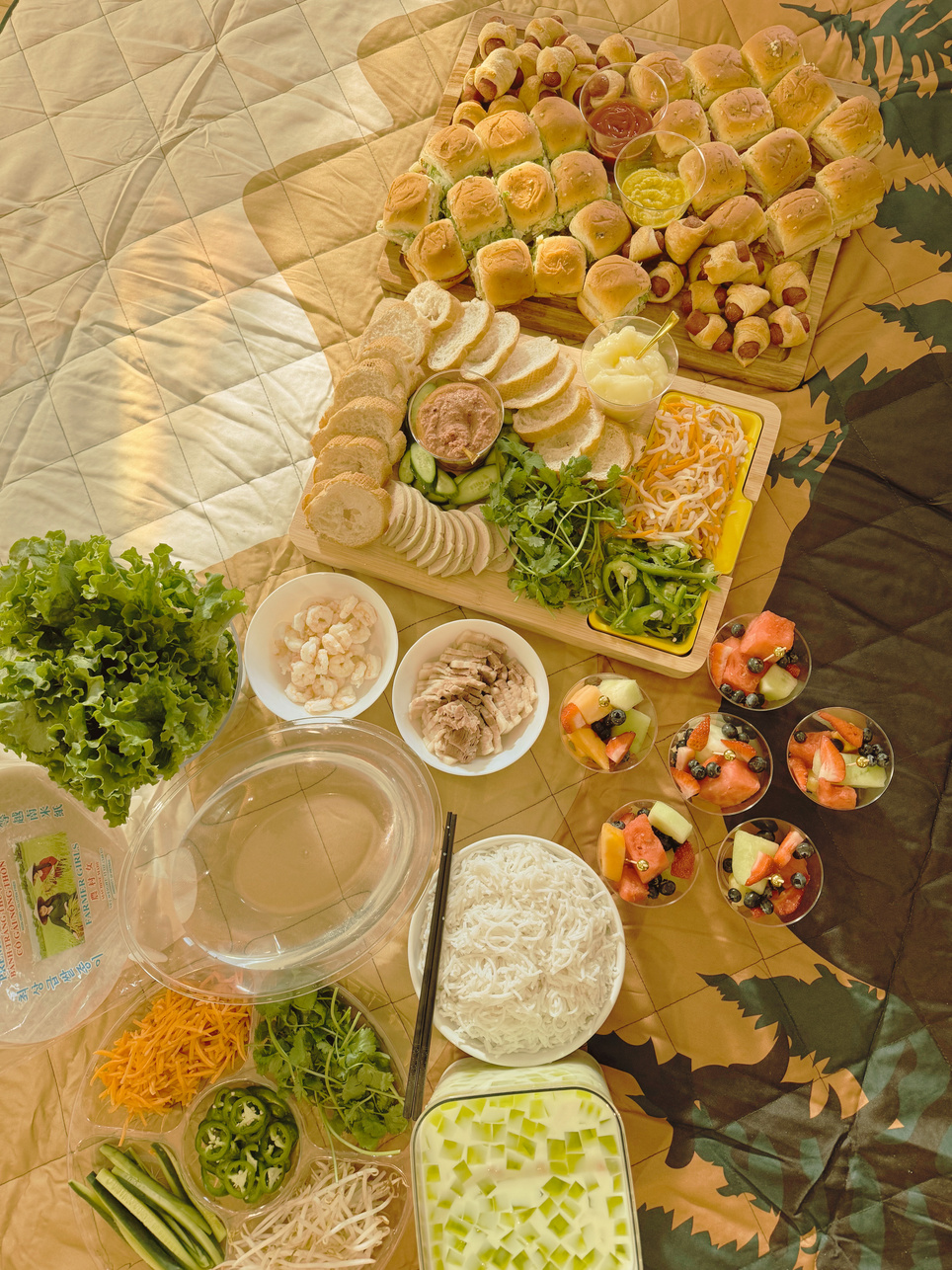 Catering food spread with sliders, salads, and fruit