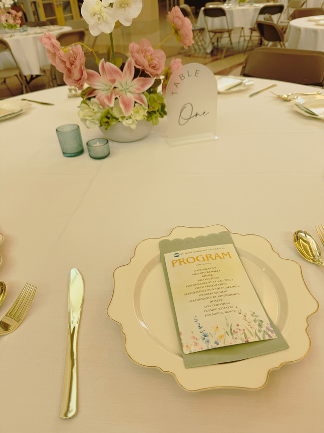 Elegant table setting with floral arrangement and program card