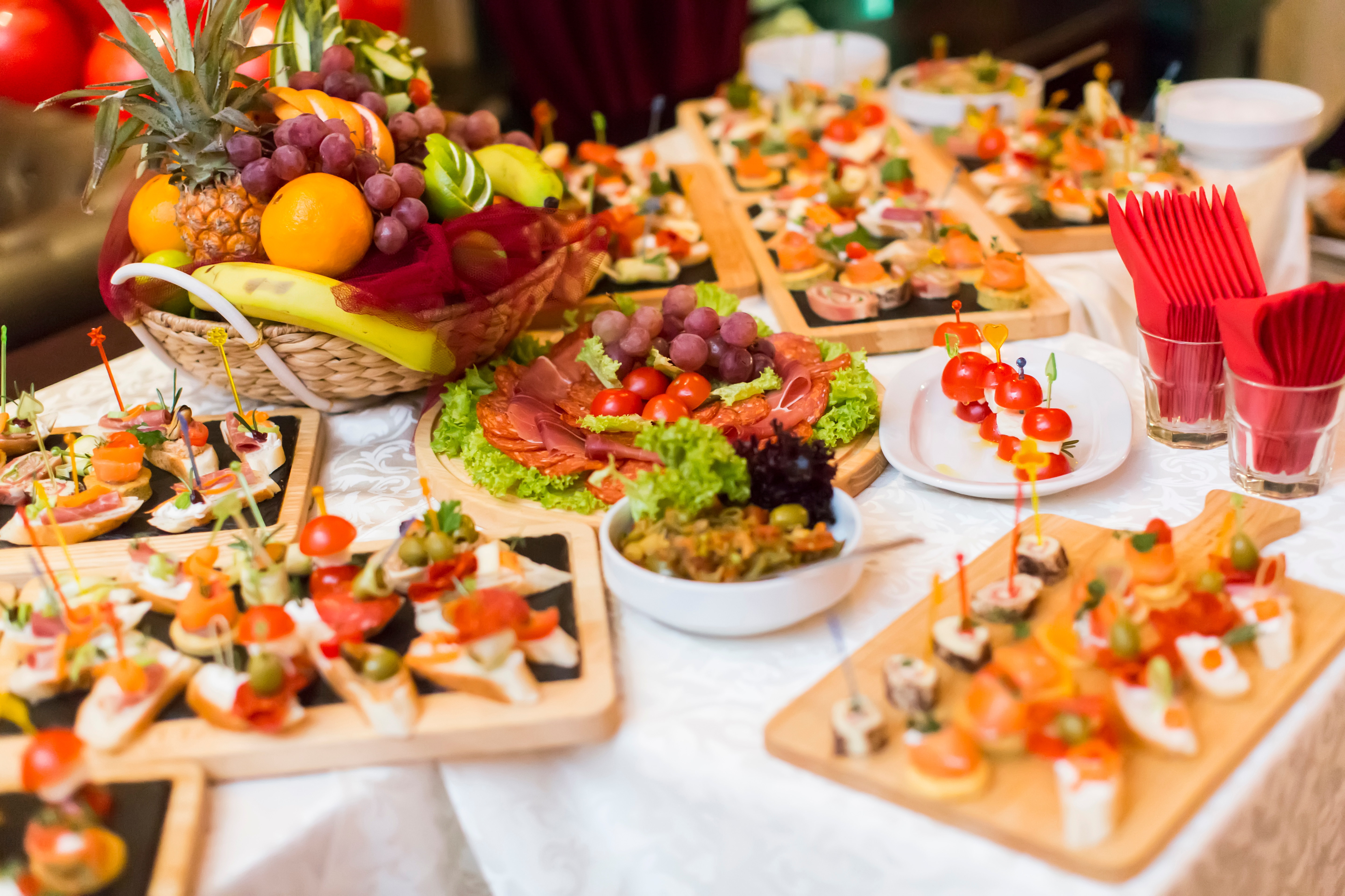 Beautifully arranged event catering spread with appetizers, fruits, and garnishes